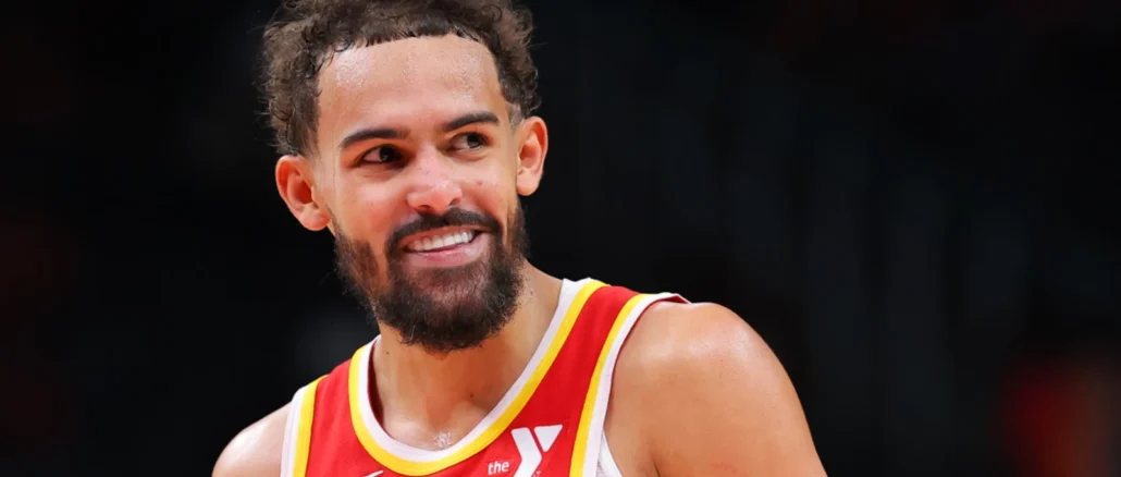 trae-young-of-the-atlanta-hawks-smiles-at-the-bench-during-opening-night-against-the-brooklyn-nets-at-state-farm-arena